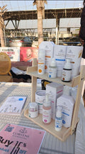 Display of skincare products on a wooden stand with a Corvene sign in the background.