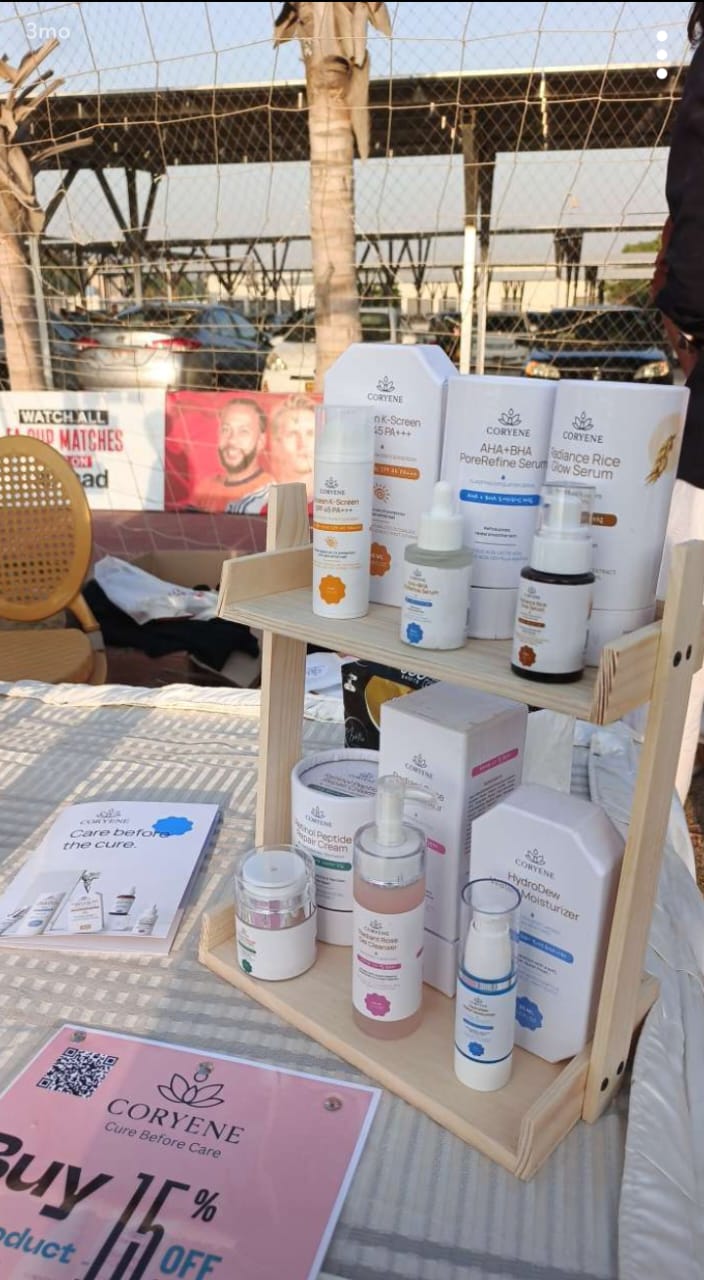 Display of skincare products on a wooden stand with a Corvene sign in the background.